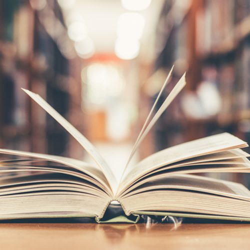 Book,In,Library,With,Old,Open,Textbook,,Stack,Piles,Of