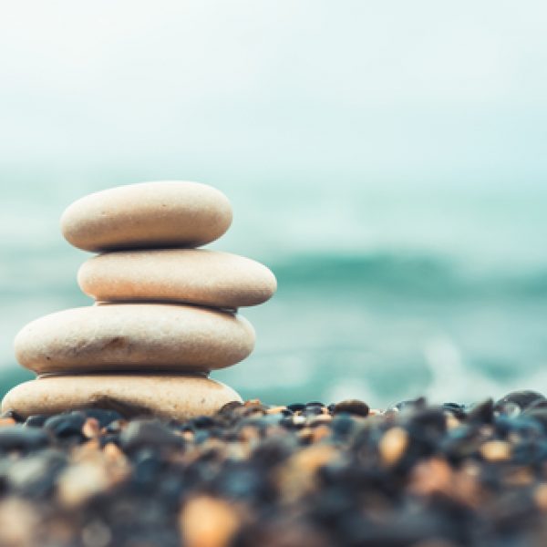 Stones,Pyramid,On,Pebble,Beach,Symbolizing,Stability,,Zen,,Harmony,,Balance.